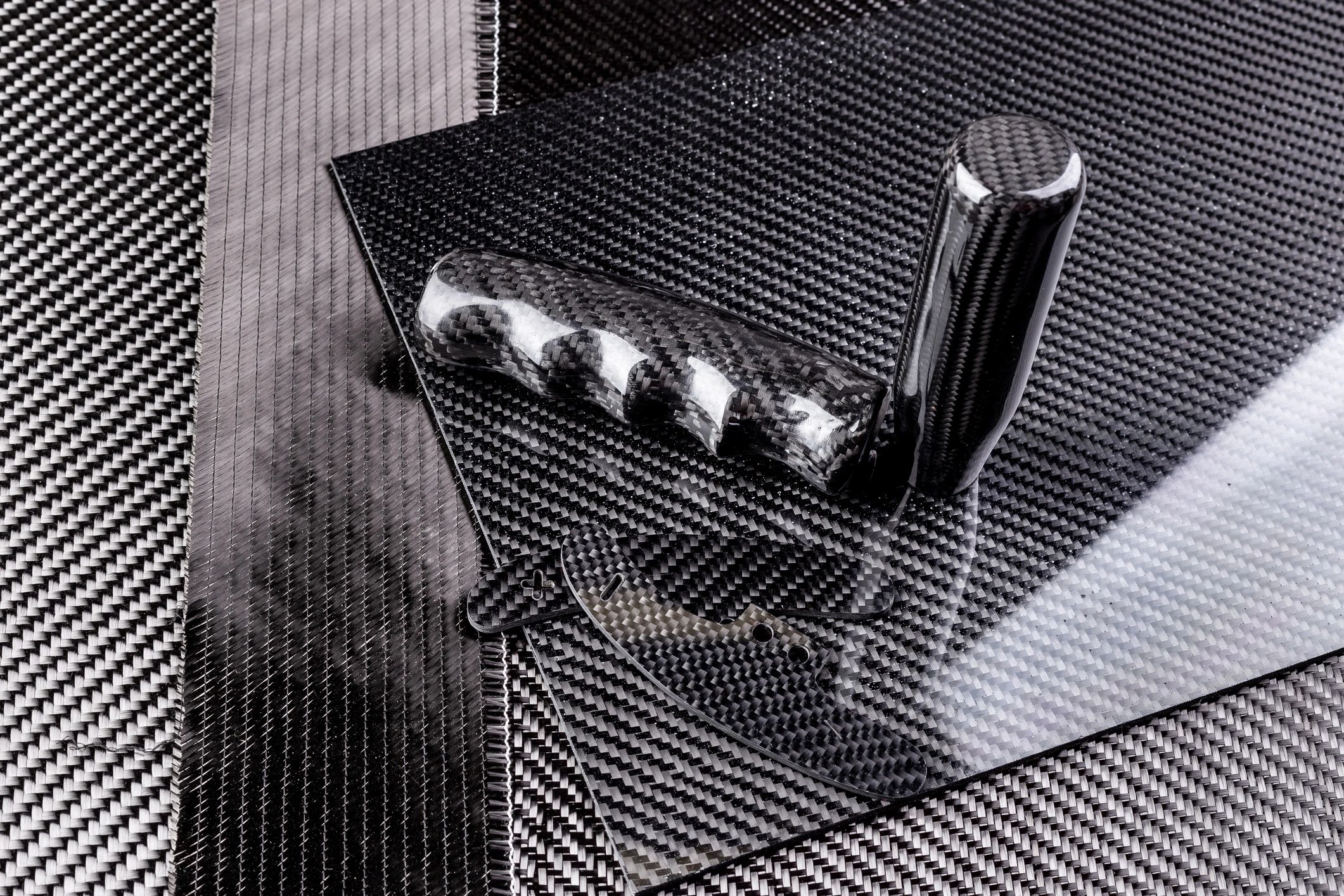 Rolls of woven carbon fiber cloth in a workshop